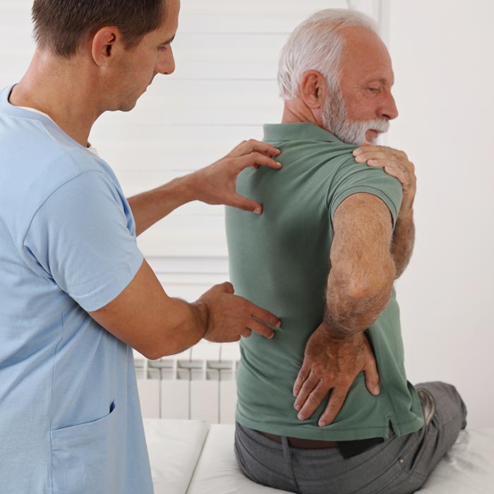 doctor touching patient's back